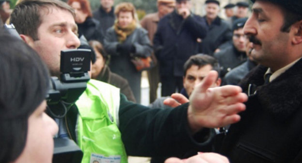 Репортер и полиция на митинге обманутых дольщиков перед зданием администрации президента Азербайджана. Баку, 18 января 2012 г. Фото: www.irfs.az