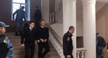 Никита Журавель (в центре) в коридоре суда. Фото: СУ СКР по Волгоградской области